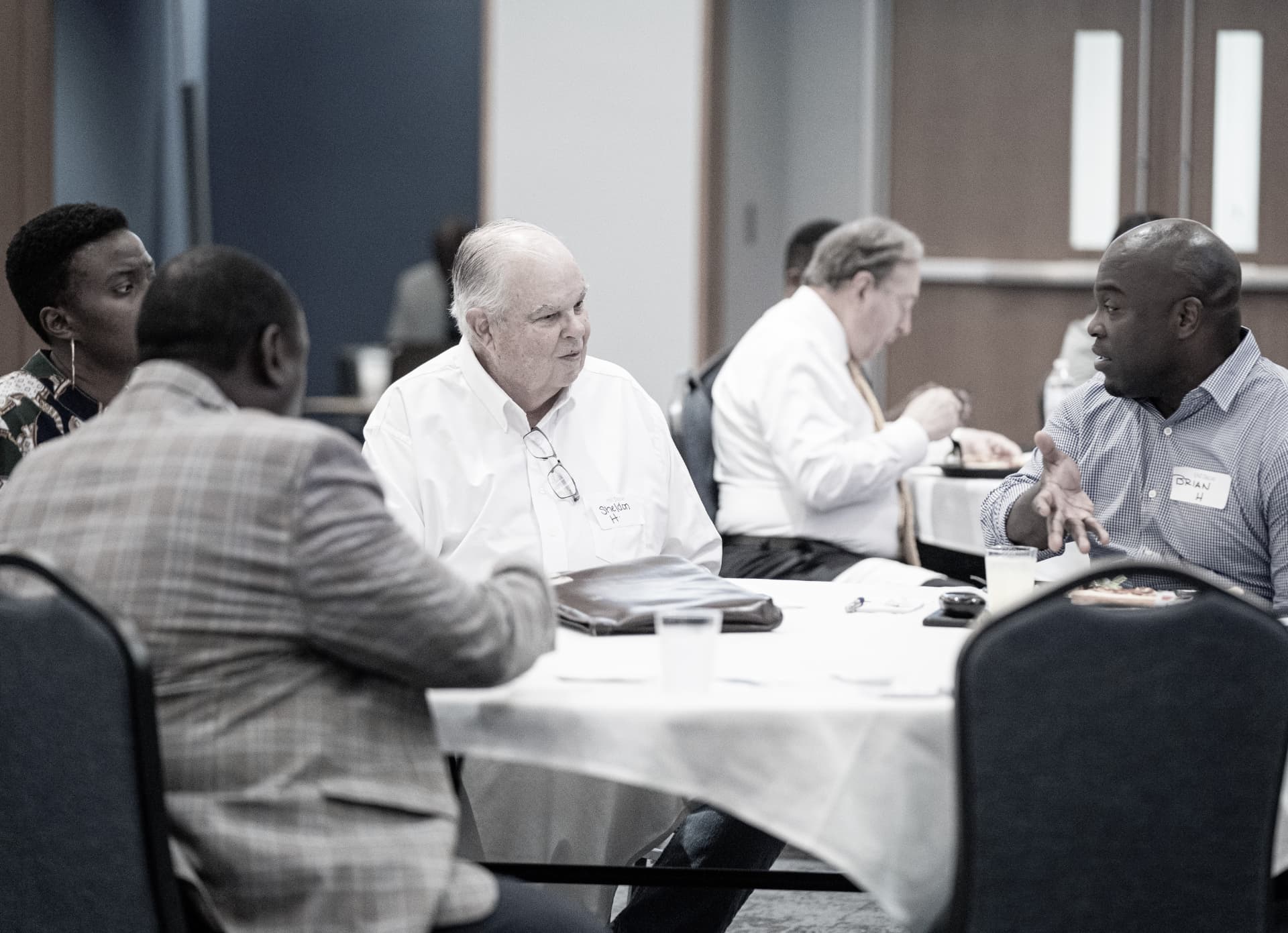 Guests trading stories over lunch at The Gold Chair luncheon