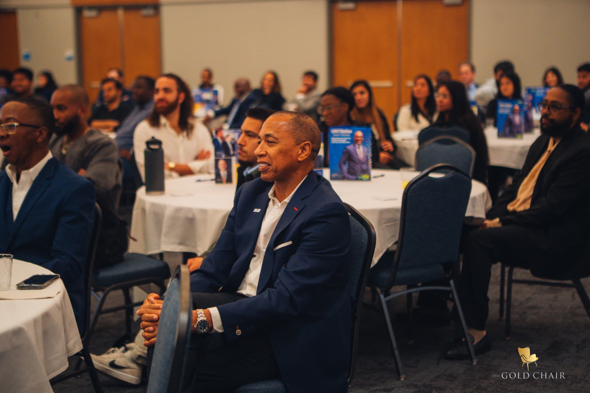 An attendee smiling during The Gold Chair program