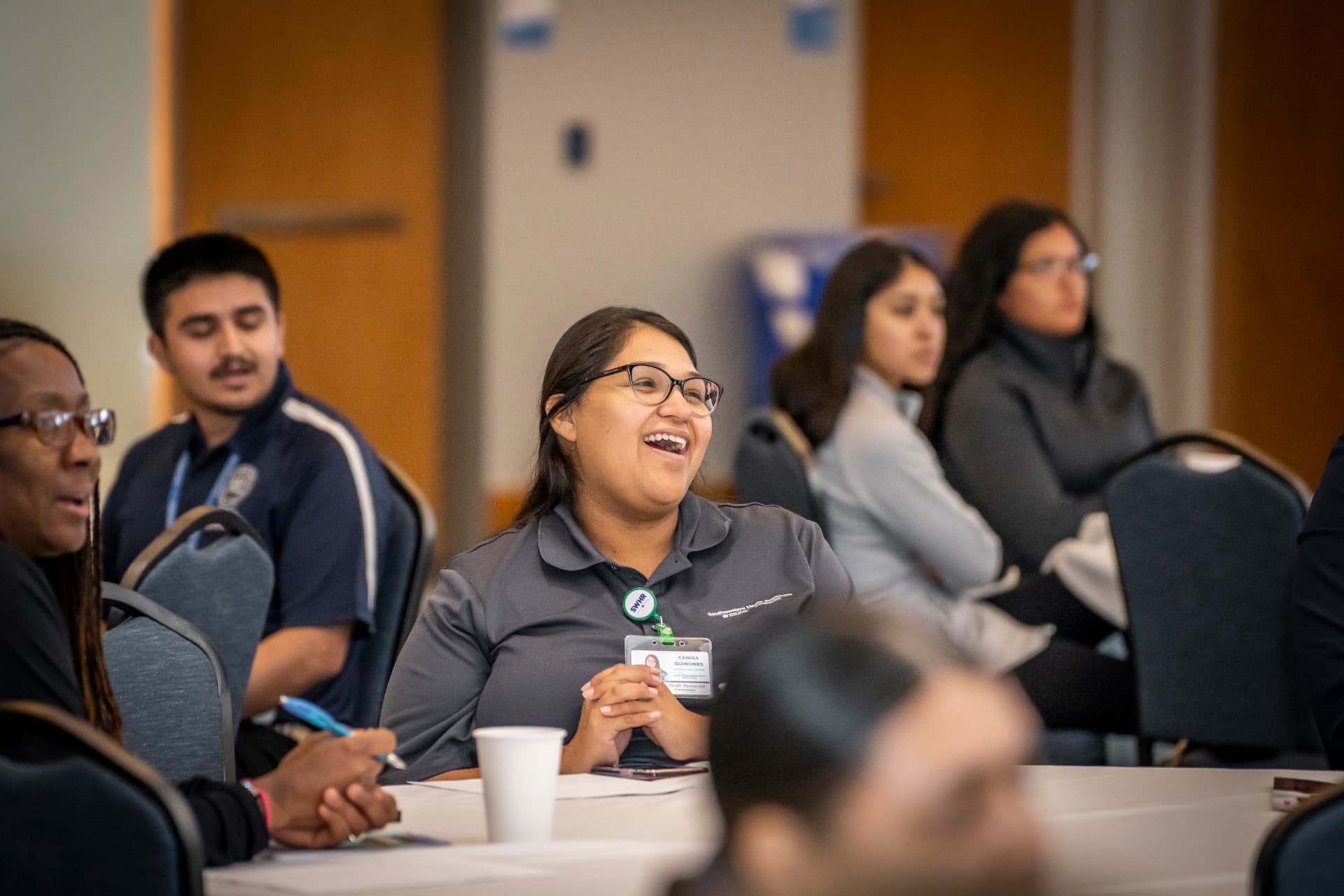 An attendee smiling during The Gold Chair program