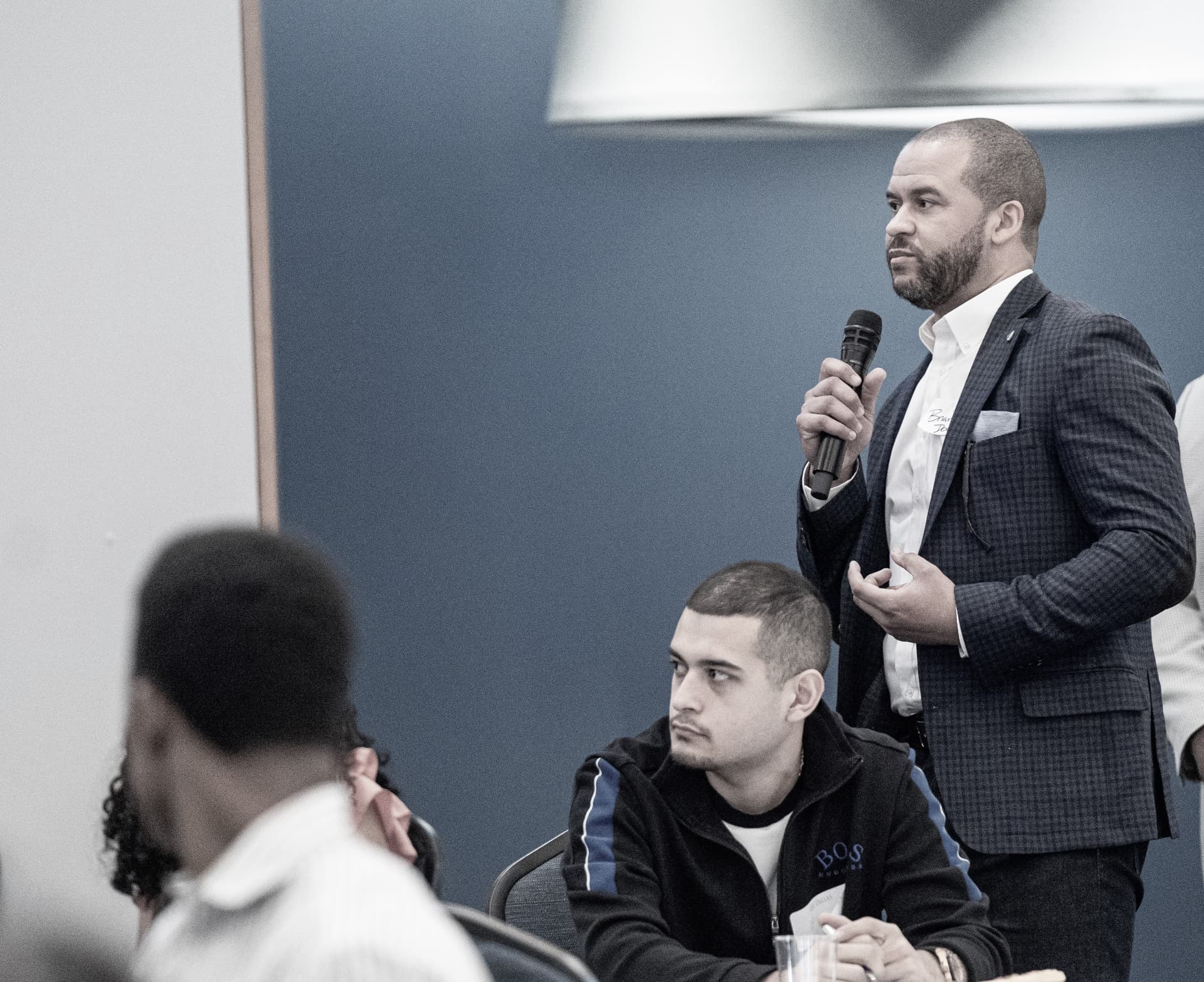 An attendee asking a question at The Gold Chair