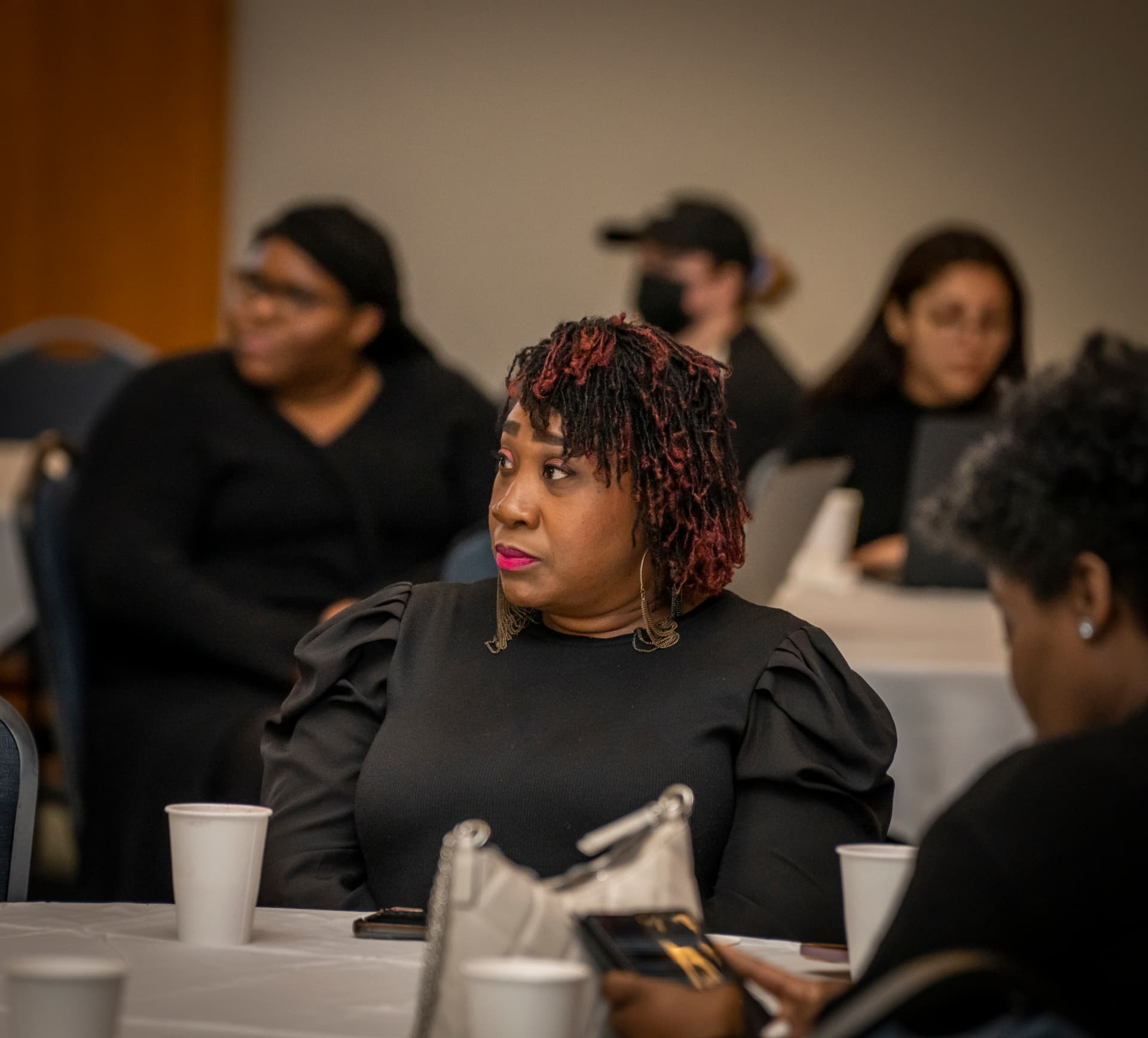 An attendee listening closely during The Gold Chair luncheon