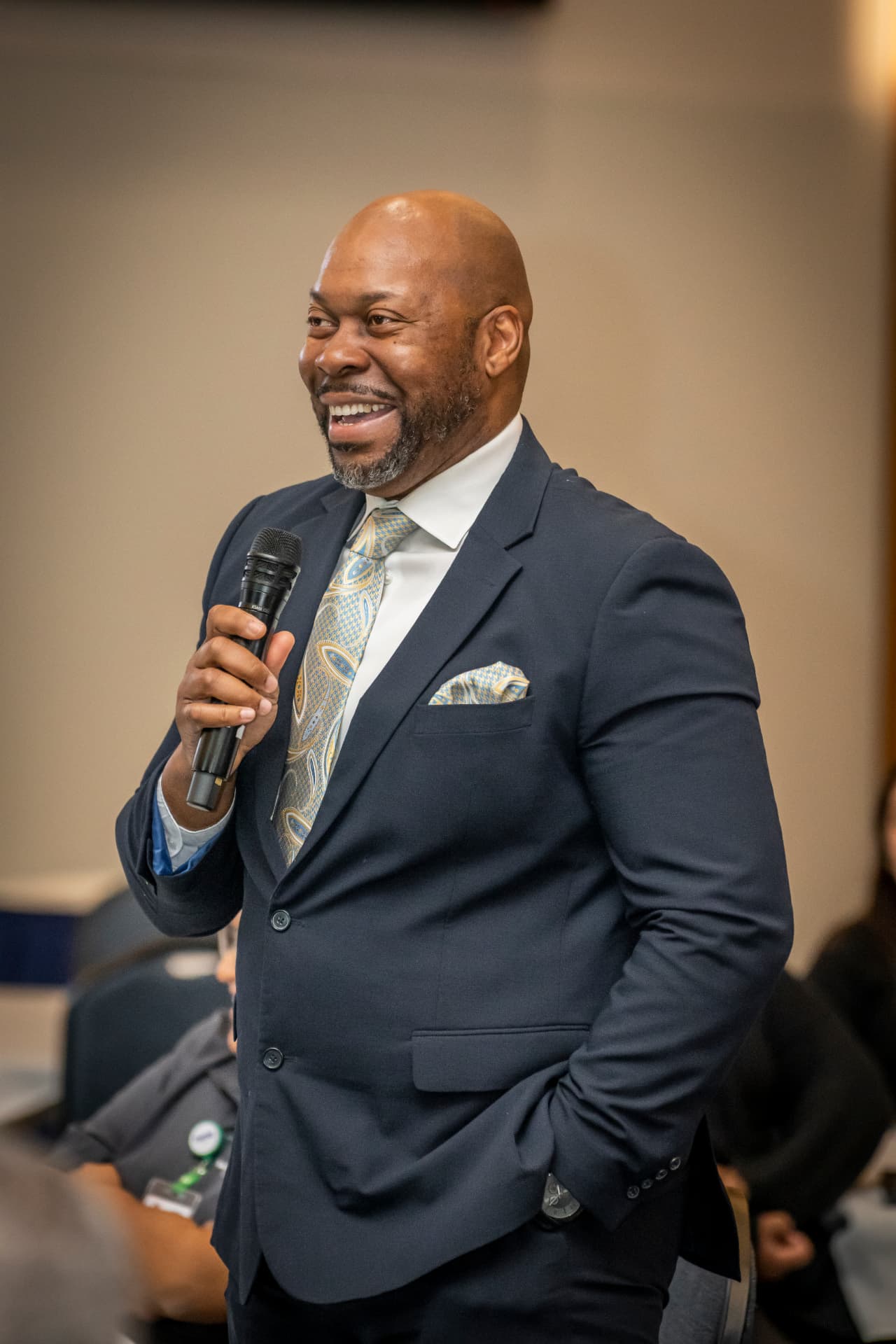 A speaker sharing words of encouragement at The Gold Chair